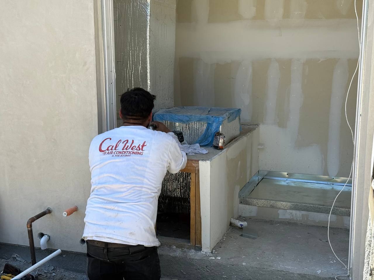 Joe Alvarado working in a mechanical room before the FAU was installed