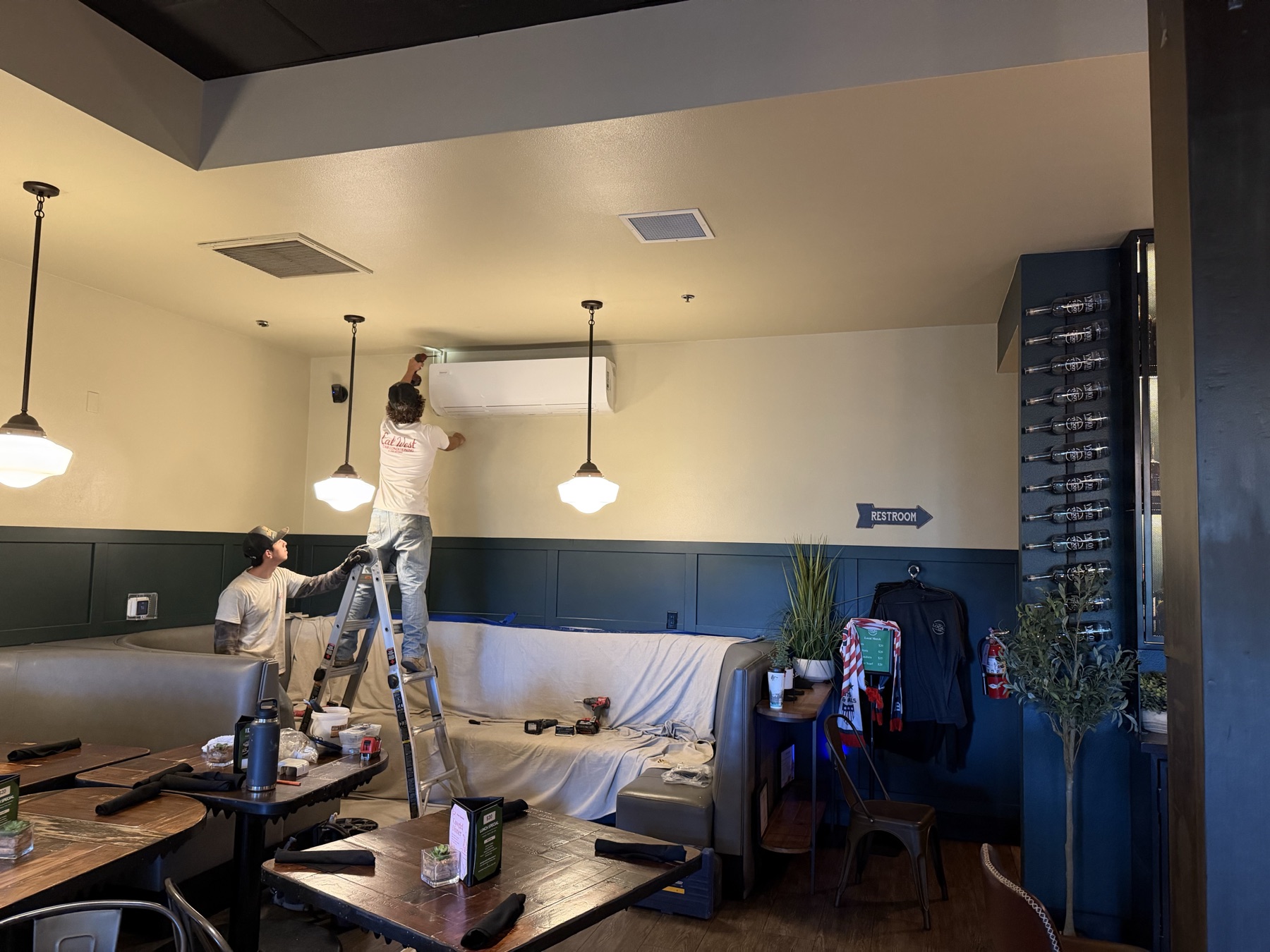 Cal West crew installing a large mini split in a restaurant dining room